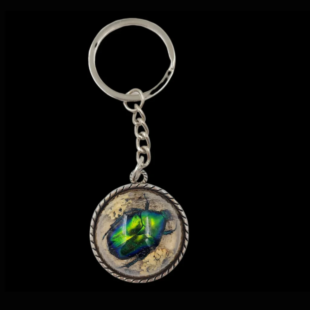 keychain featuring a real metallic-green jewel beetle