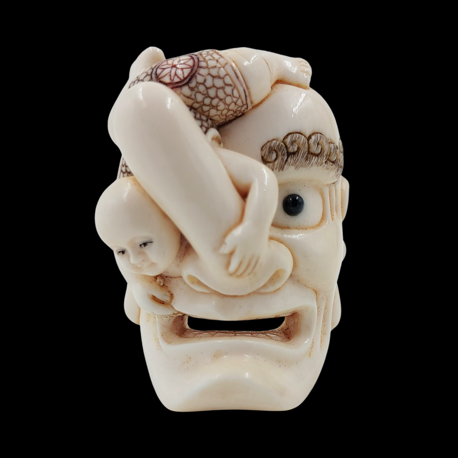 Japanese Netsuke Depicting a Child upon an Oni Mask Japanese Netsuke Depicting a Child upon an Oni Mask123