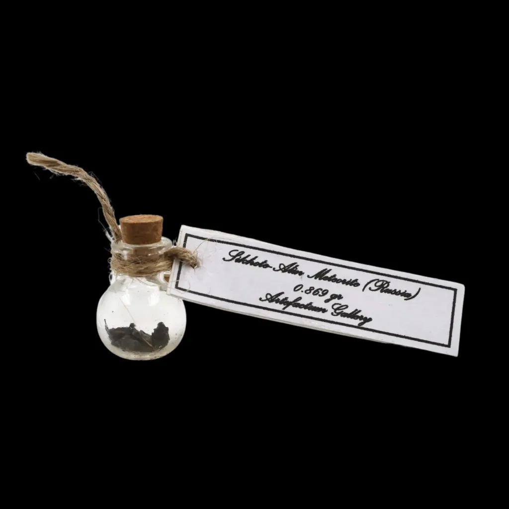 0.869 g Sikhote-Alin meteorite in sealed round bottle - preview photo 1123